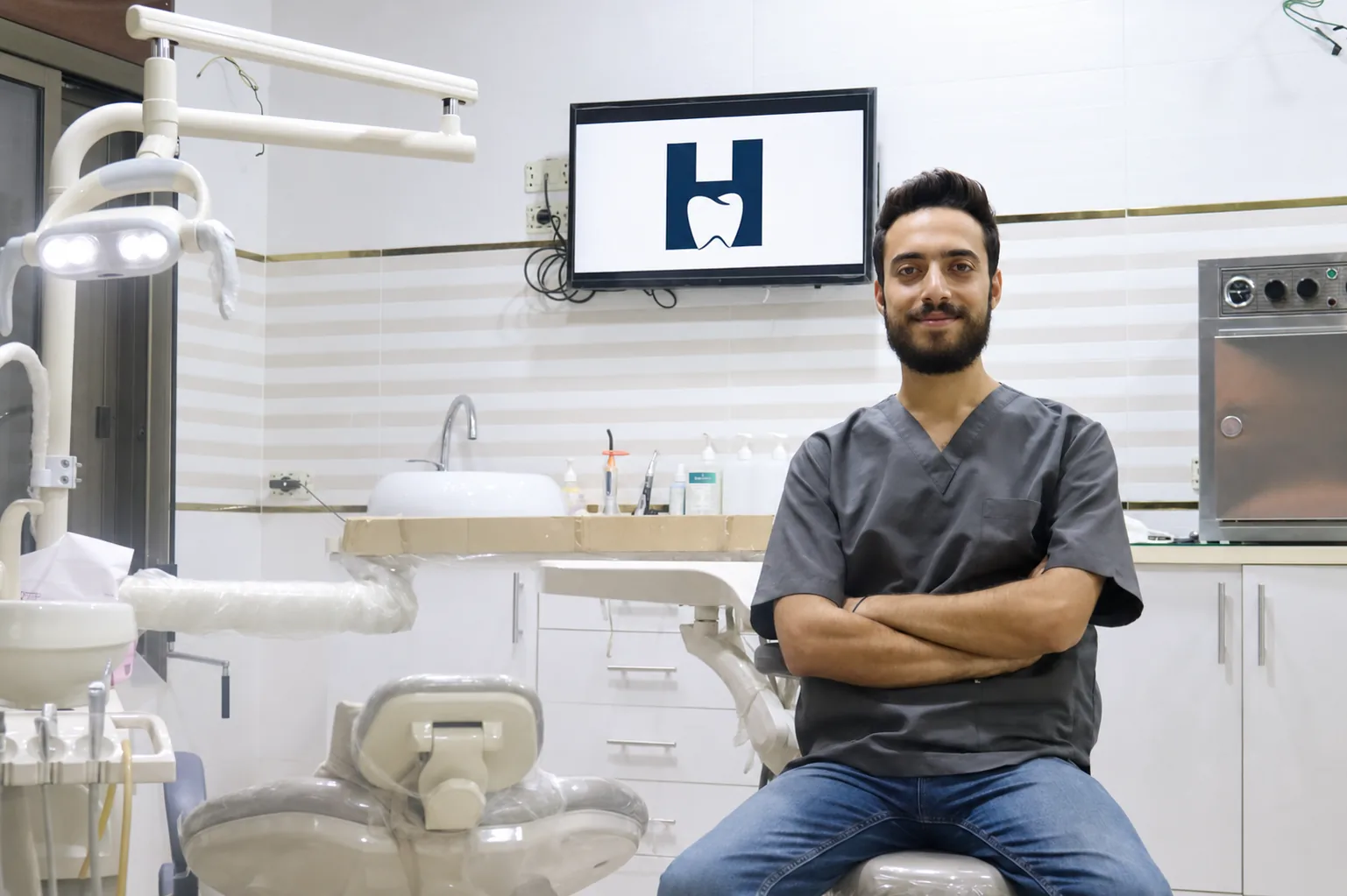 Dr. Hussam Alsaddi in the dental clinic